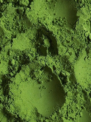 Extreme close up of vivid green matcha powder showing its fine texture